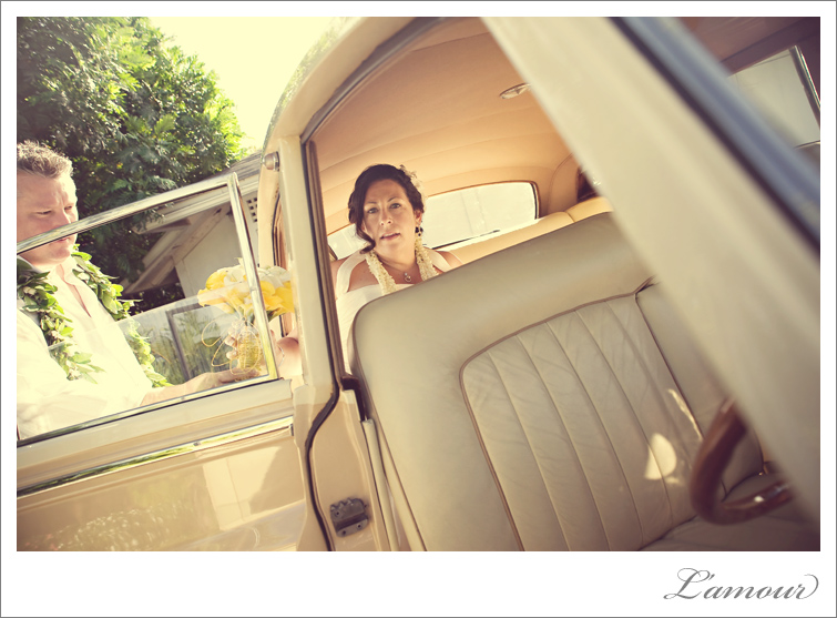 Hawaii Destination Wedding couple drive away in vintage car Rolls Royce