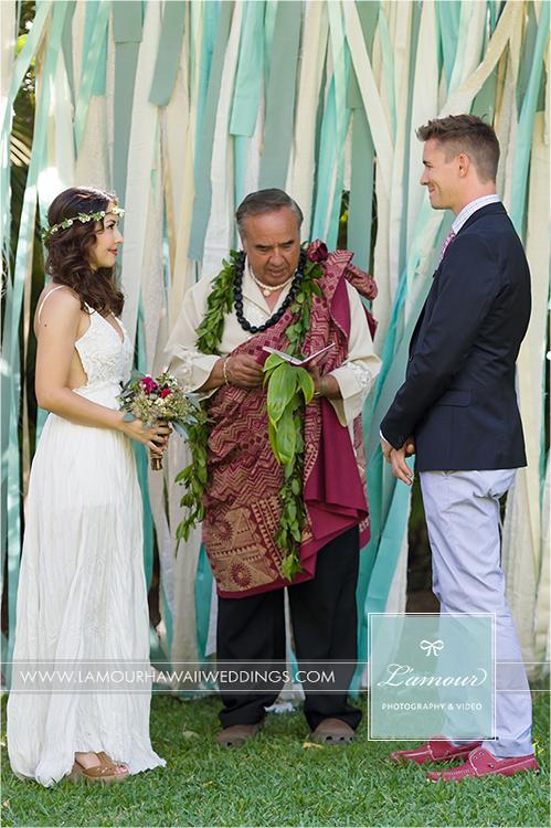 Wedding ceremony with floral headpiece haku with ribbon backdrop in hawaii