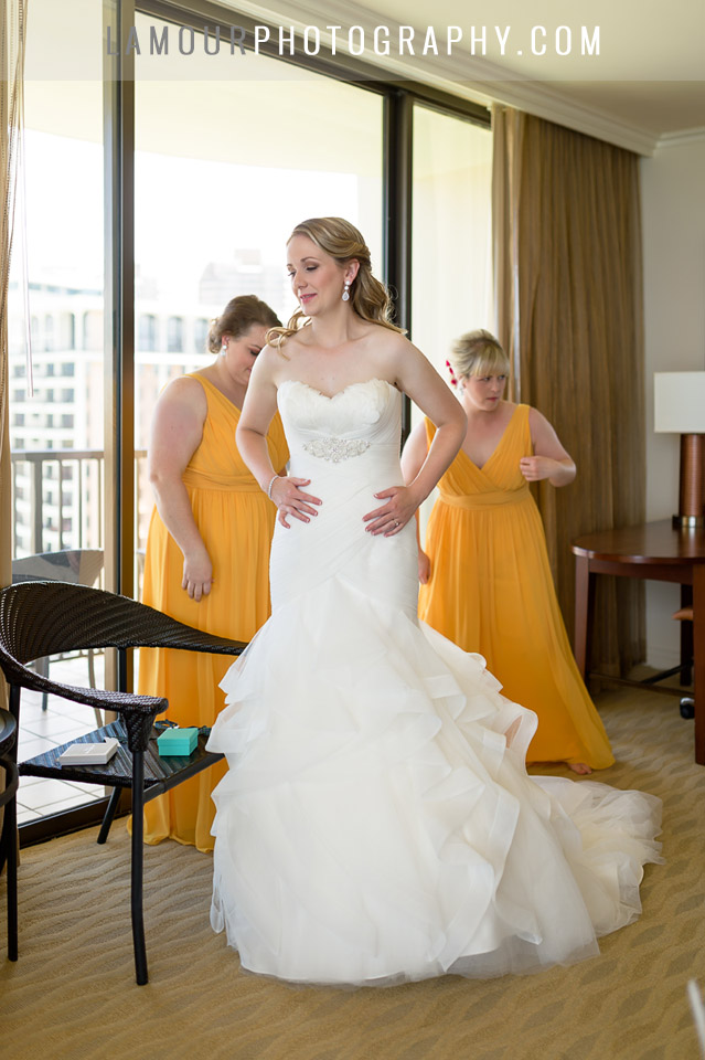 Bride in Hawaii gets dressed in flowing dress at Hilton Hawaiian Village