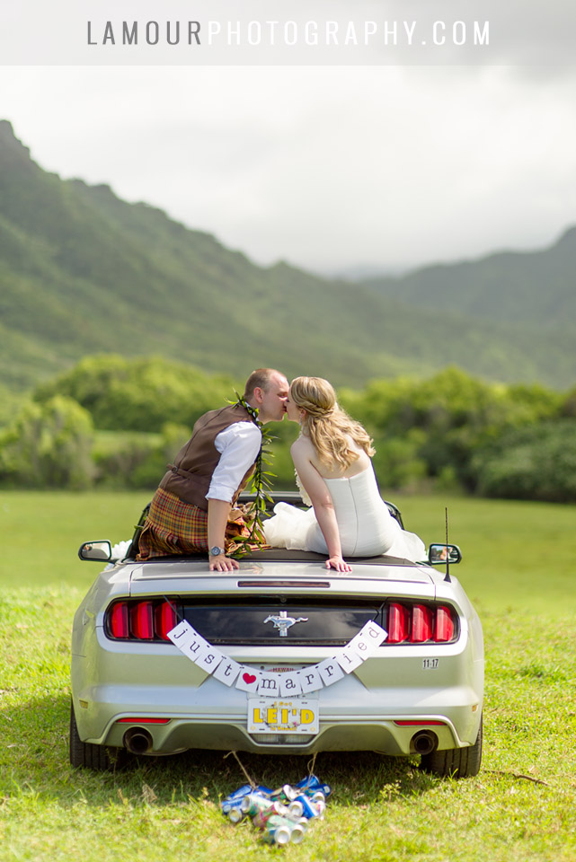 Heading off in a convertible mustang at Kualoa Ranch for this hawaii wedding
