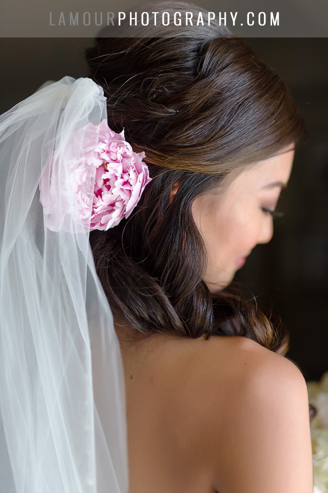 hawaii wedding bride wears pink flower in her hair for ceremony at turtle bay