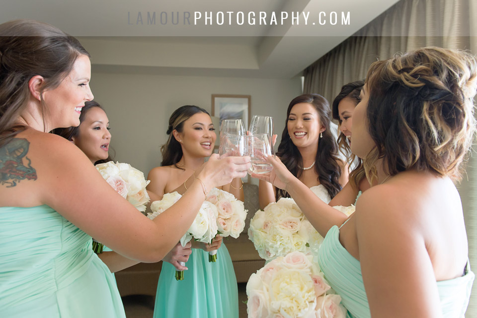 bride toasts champagne in bridal suite at turtle bay