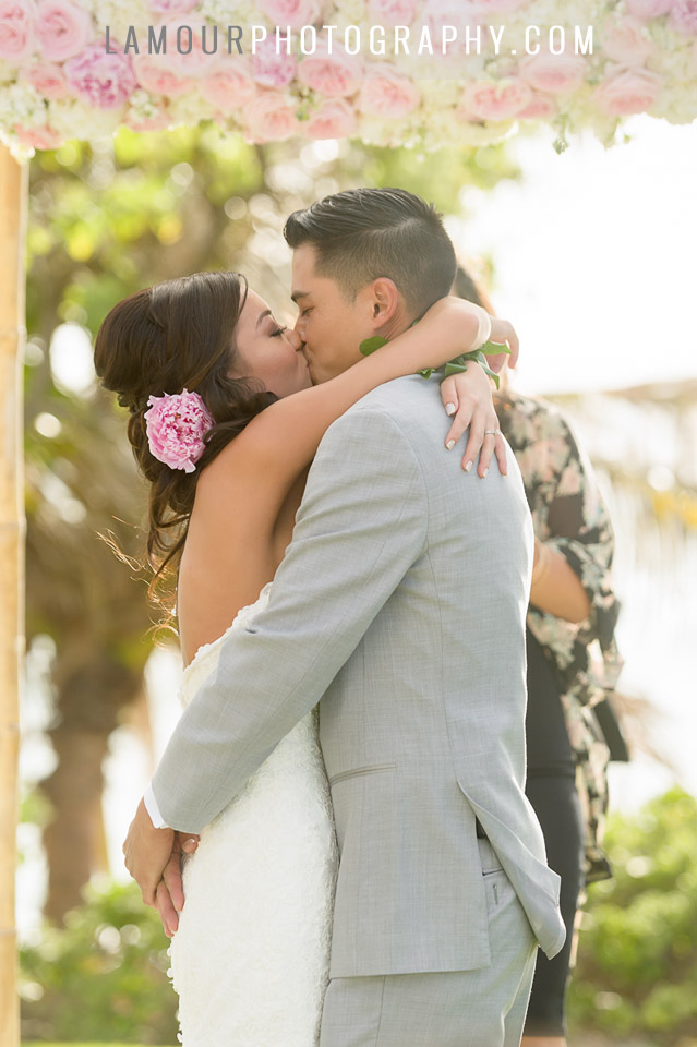 bride and groom share first kiss at hawaii wedding at venue turtle bay resort oahu