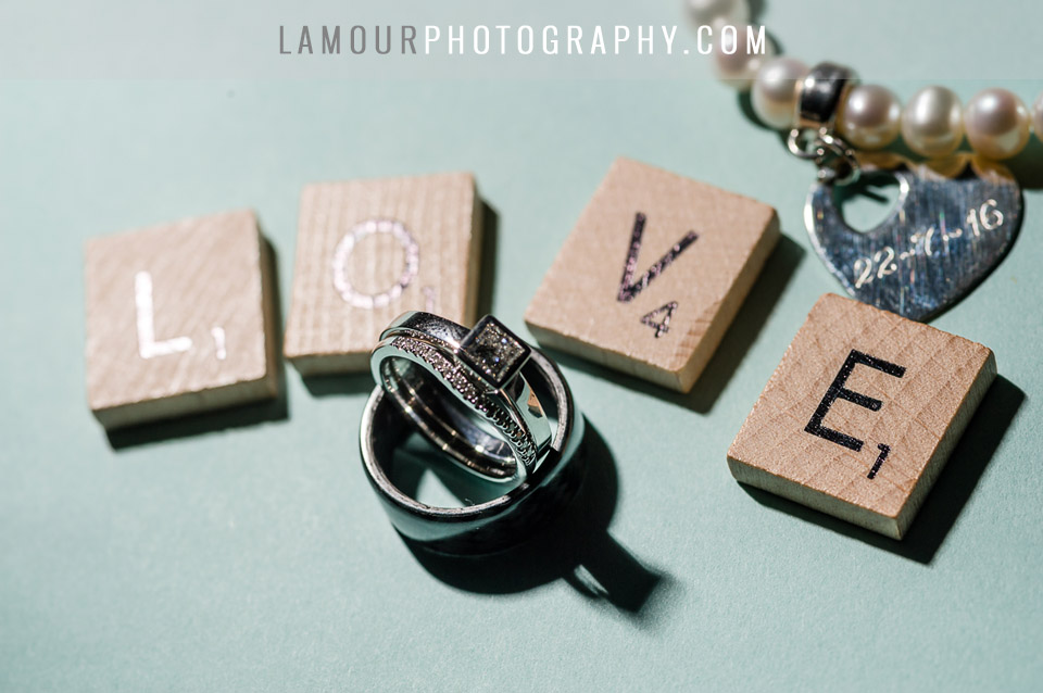 scrabble pieces spell love with wedding rings for hawaiian ceremony