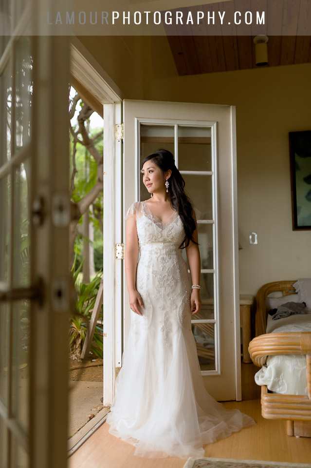 hawaii beach wedding bride looks out window before ceremony