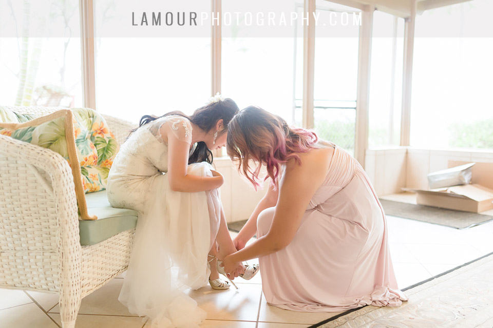 bride gets wedding shoes on in wedding photography