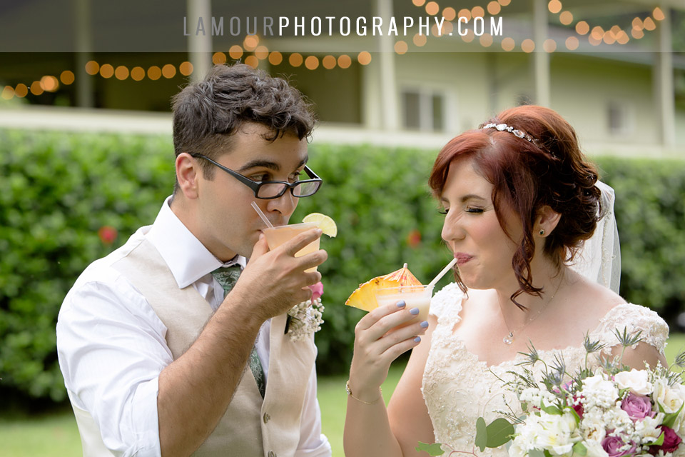 Hawaii wedding bride and groom sip mai tais during their cocktail hour