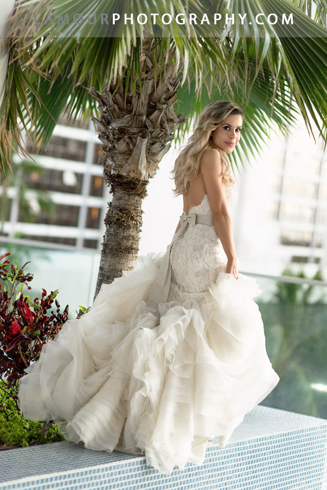 Hawaii wedding photographers from the team at L'amour photograph this gorgeous bride in her flowing destination wedding dress