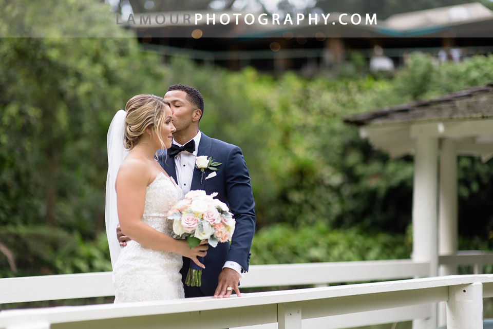 Hawaii wedding groom sweetly kisses bride on forehead 