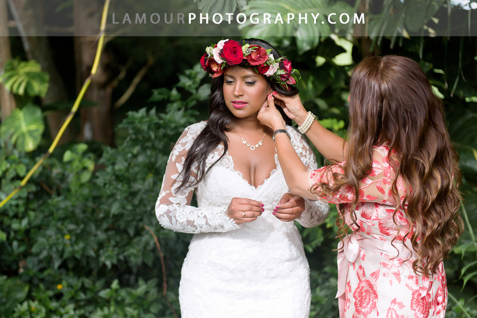 Hawaii bride gets ready in her lace wedding dress with long sleeves 