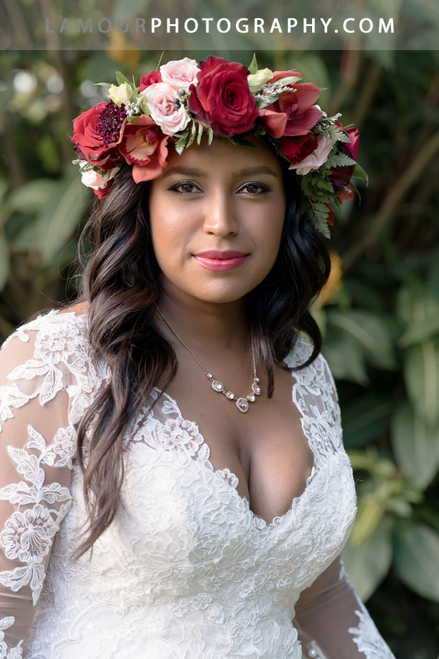 Kualoa Ranch bride wears a red flower crown or haku for her wedding on oahu