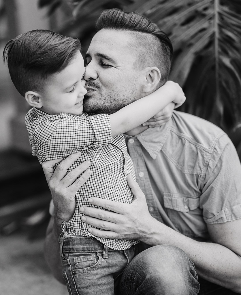 Eric kissing a child he is holding
