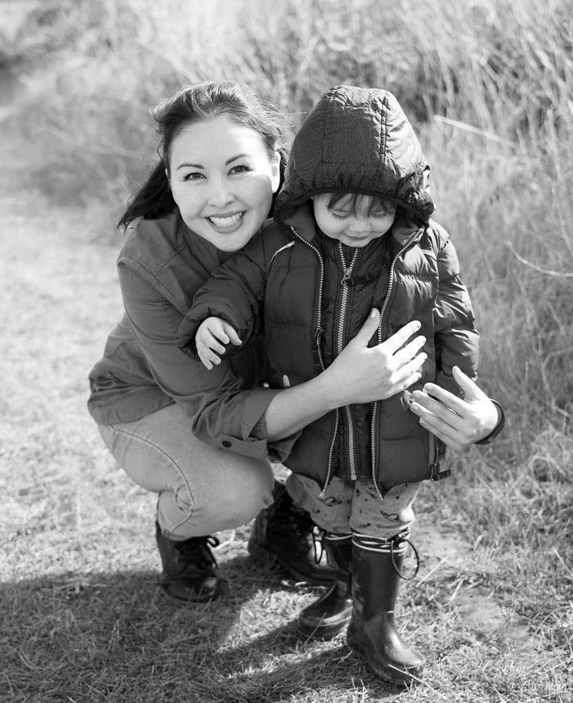 Wendy smiling beside a child outdoors